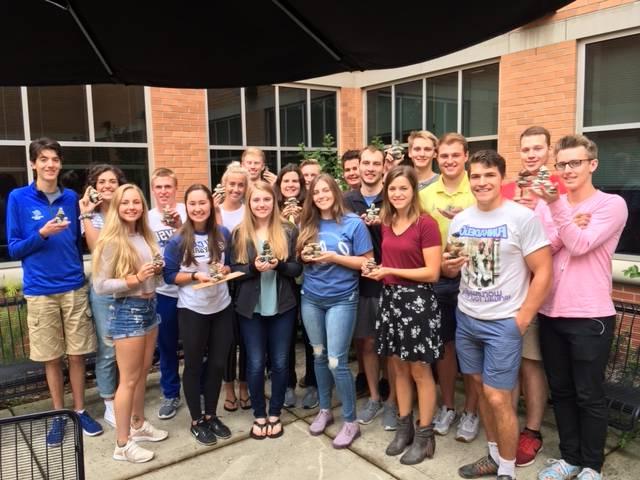 John Kilbourne's class holding small Inuksuks they made in class